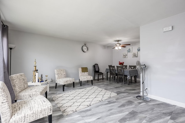 8821 N Washington St Unit F, Niles, IL 60714 - living area with a ceiling fan and baseboards