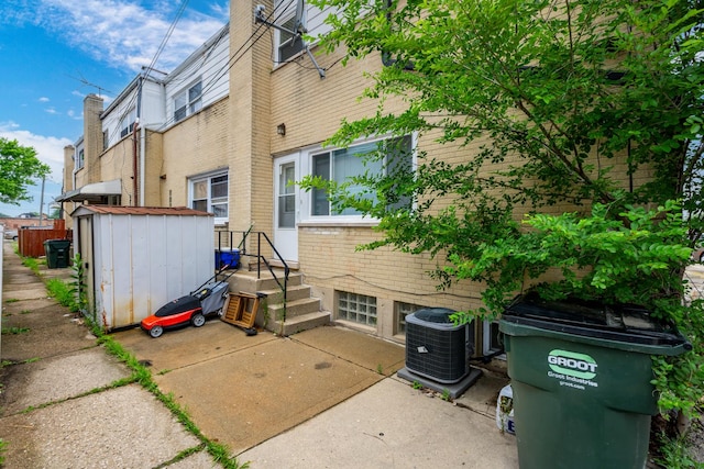 8821 N Washington St Unit F, Niles, IL 60714 - back of property featuring a storage unit and brick siding