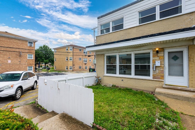 8821 N Washington St Unit F, Niles, IL 60714 - view of property exterior featuring brick siding and uncovered parking