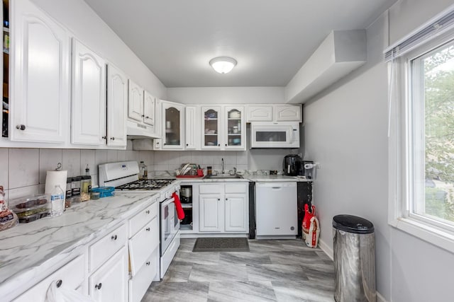 8821 N Washington St Unit F, Niles, IL 60714 - kitchen featuring white appliances, glass insert cabinets, white cabinets, backsplash, and under cabinet range hood