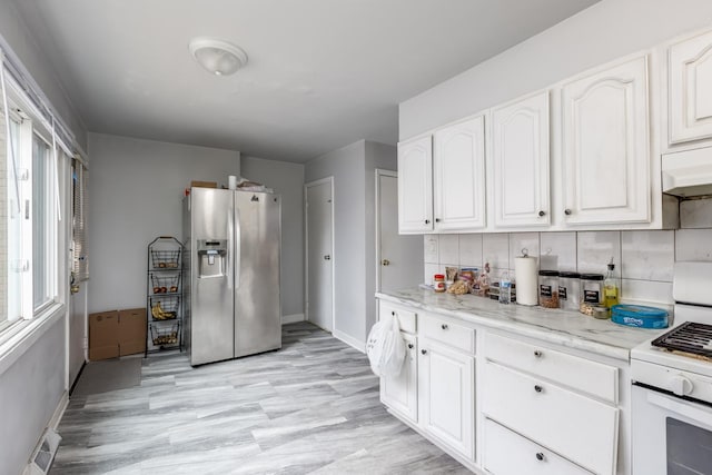8821 N Washington St Unit F, Niles, IL 60714 - kitchen with stainless steel refrigerator with ice dispenser, white cabinets, light stone countertops, and light wood-style flooring