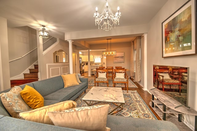2718 W Washington Blvd, Chicago, IL 60612 - living room featuring a chandelier, wood finished floors, stairs, and decorative columns