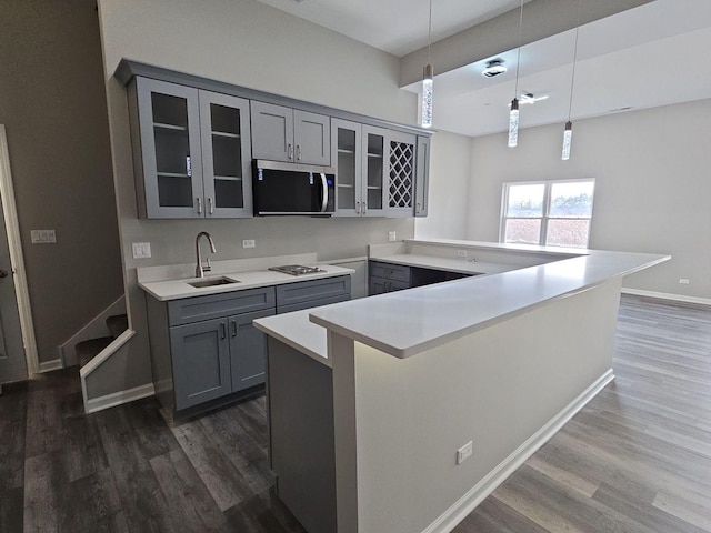 1221 Honey Lake Rd, Lake Zurich, IL 60047 - kitchen featuring stainless steel microwave, gray cabinetry, a peninsula, glass insert cabinets, and dark wood-style flooring