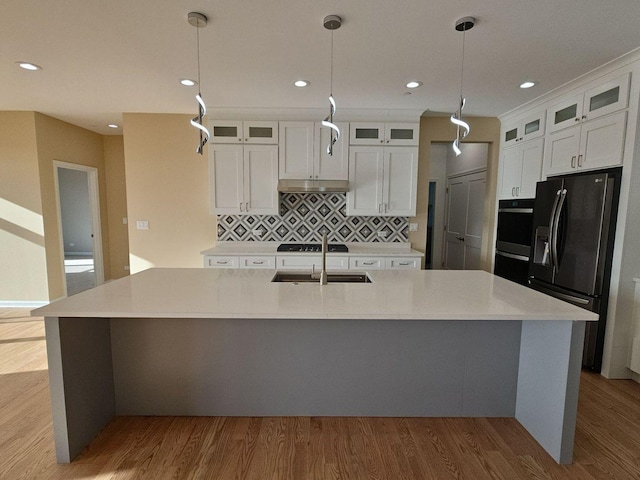 1221 Honey Lake Rd, Lake Zurich, IL 60047 - kitchen with fridge with ice dispenser, a large island, stainless steel double oven, wood finished floors, and backsplash