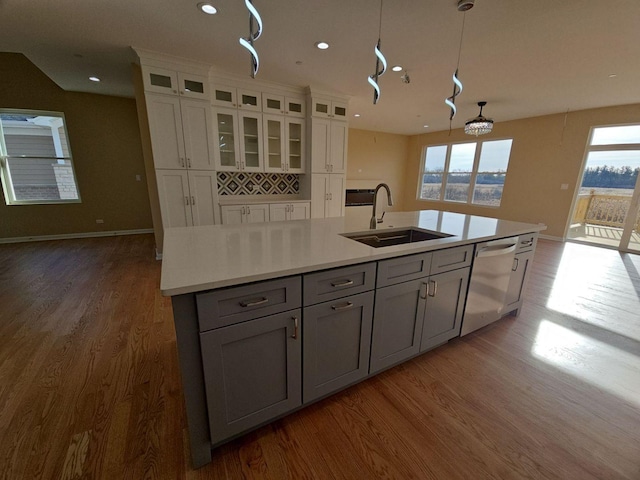 1221 Honey Lake Rd, Lake Zurich, IL 60047 - kitchen with stainless steel dishwasher, wood finished floors, plenty of natural light, white cabinetry, and recessed lighting