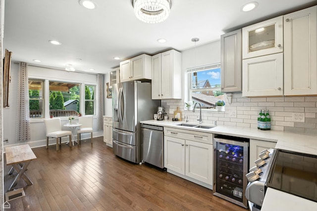 7515 W Roscoe St, Chicago, IL 60634 - kitchen featuring beverage cooler, appliances with stainless steel finishes, light countertops, plenty of natural light, and recessed lighting