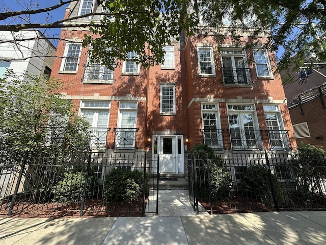 1617 N Hermitage Ave Unit 1S, Chicago, IL 60622 - view of front of property featuring brick siding, a fenced front yard, and a gate