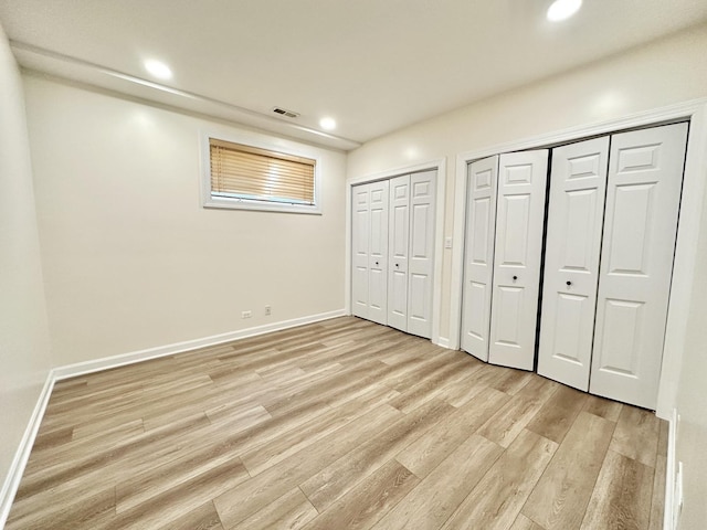 1617 N Hermitage Ave Unit 1S, Chicago, IL 60622 - unfurnished bedroom featuring light wood-style floors, two closets, and recessed lighting