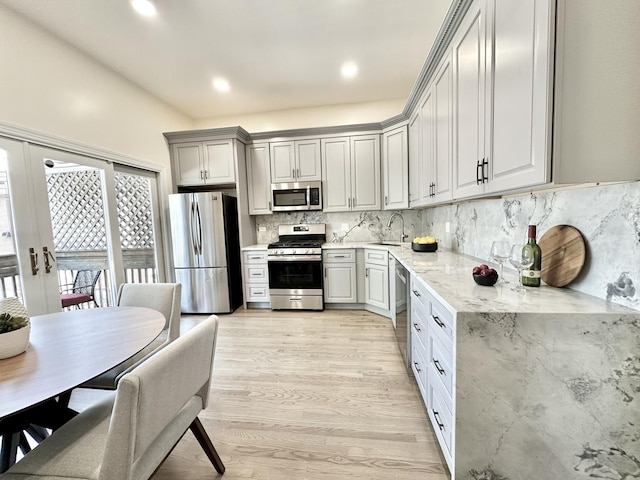 1617 N Hermitage Ave Unit 1S, Chicago, IL 60622 - kitchen featuring stainless steel appliances, light wood-style flooring, tasteful backsplash, light stone countertops, and french doors