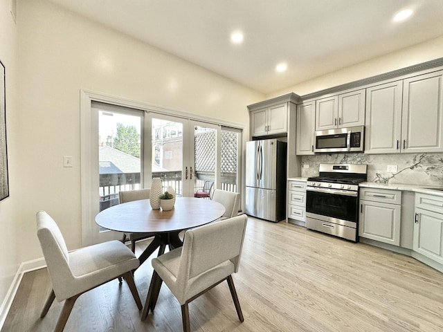 1617 N Hermitage Ave Unit 1S, Chicago, IL 60622 - kitchen featuring appliances with stainless steel finishes, light countertops, tasteful backsplash, light wood-style floors, and gray cabinetry