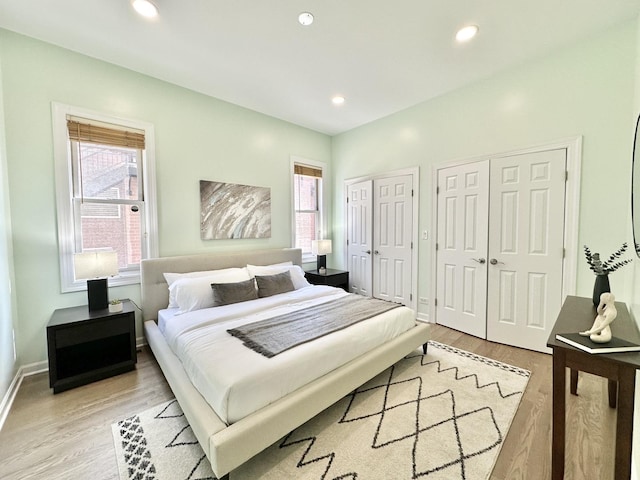 1617 N Hermitage Ave Unit 1S, Chicago, IL 60622 - bedroom featuring two closets, light wood-style flooring, and recessed lighting