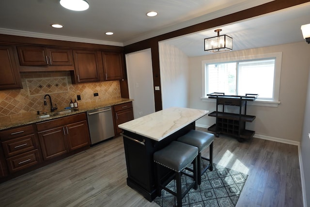 2304 Jay Ln, Rolling Meadows, IL 60008 - kitchen with stainless steel dishwasher, light wood finished floors, decorative backsplash, a kitchen breakfast bar, and recessed lighting