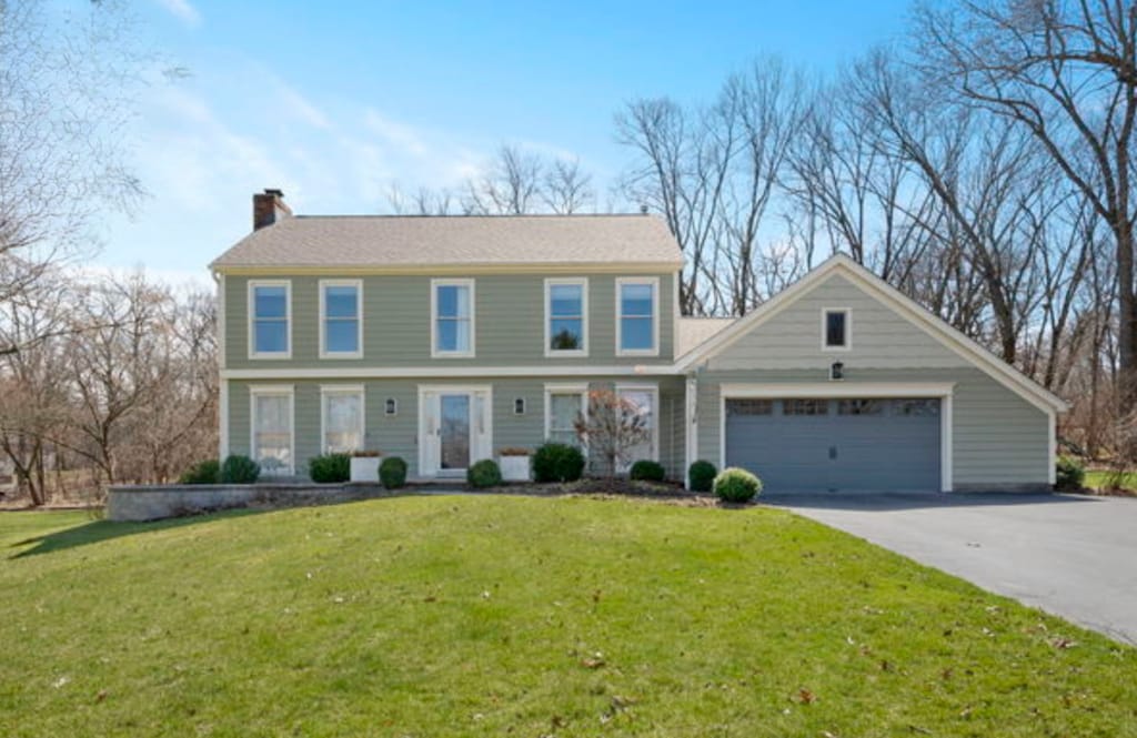 6801 Connecticut Trl, Crystal Lake, IL 60012 - colonial inspired home with a chimney, an attached garage, a front yard, and driveway