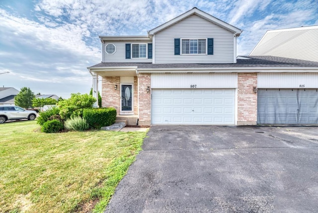 807 Harris Ln Unit 807, Romeoville, IL 60446 - traditional home featuring a front lawn, brick siding, driveway, and an attached garage