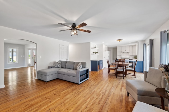 12351 W Warren Dr, Mokena, IL 60448 - living area featuring arched walkways, light wood-style flooring, and ceiling fan