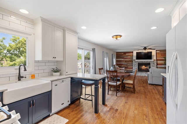 12351 W Warren Dr, Mokena, IL 60448 - kitchen featuring white appliances, ceiling fan, white cabinets, a fireplace, and recessed lighting