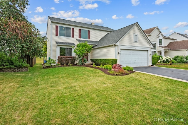 534 Ivory Ln, Bartlett, IL 60103 - traditional-style house featuring asphalt driveway, an attached garage, a front lawn, and a shingled roof