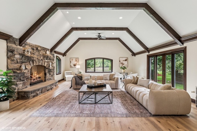 1899 Hilltop Ln, Bannockburn, IL 60015 - living room featuring wood finished floors, a ceiling fan, a stone fireplace, arched walkways, and recessed lighting