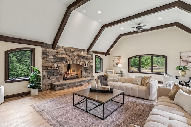 1899 Hilltop Ln, Bannockburn, IL 60015 - living area featuring plenty of natural light, a stone fireplace, beamed ceiling, wood finished floors, and a ceiling fan