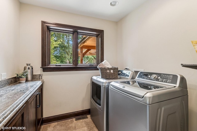 1899 Hilltop Ln, Bannockburn, IL 60015 - laundry room with independent washer and dryer, cabinet space, and light stone finish floors
