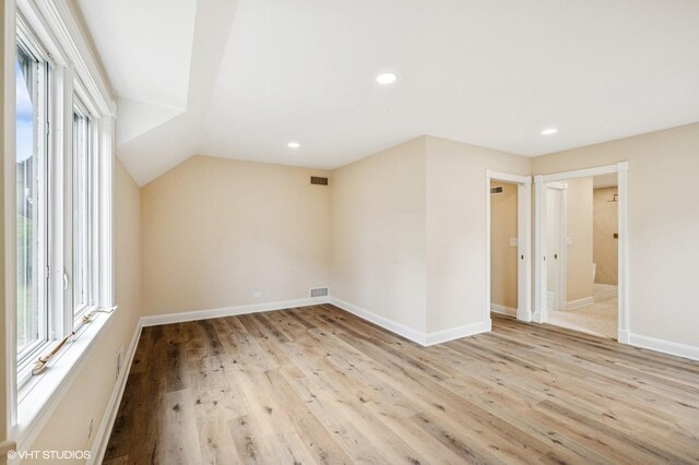 1899 Hilltop Ln, Bannockburn, IL 60015 - additional living space with plenty of natural light, light wood-style floors, recessed lighting, and vaulted ceiling