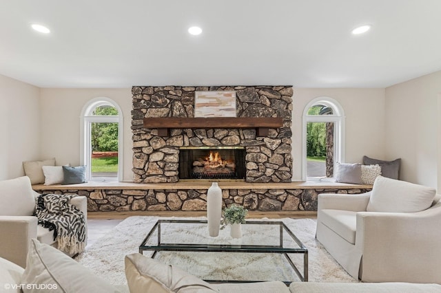 1899 Hilltop Ln, Bannockburn, IL 60015 - living area featuring healthy amount of natural light, wood finished floors, a stone fireplace, and recessed lighting