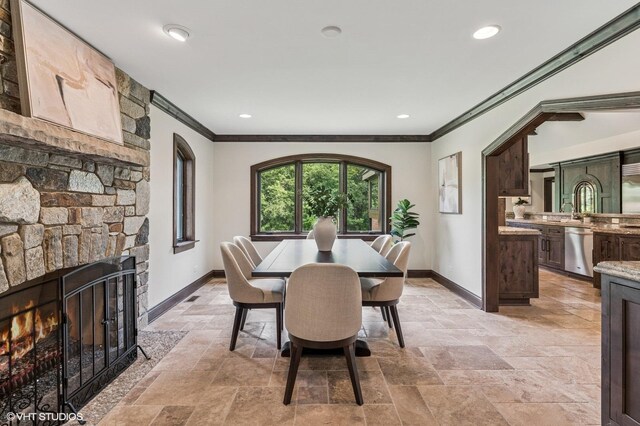 1899 Hilltop Ln, Bannockburn, IL 60015 - dining room featuring crown molding, stone tile flooring, a fireplace, and recessed lighting