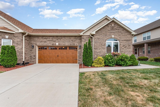 15710 S Cove Cir, Plainfield, IL 60544 - ranch-style house featuring an attached garage, brick siding, concrete driveway, and a front lawn