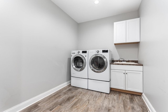 15710 S Cove Cir, Plainfield, IL 60544 - washroom featuring cabinet space, washing machine and clothes dryer, and light wood-style flooring