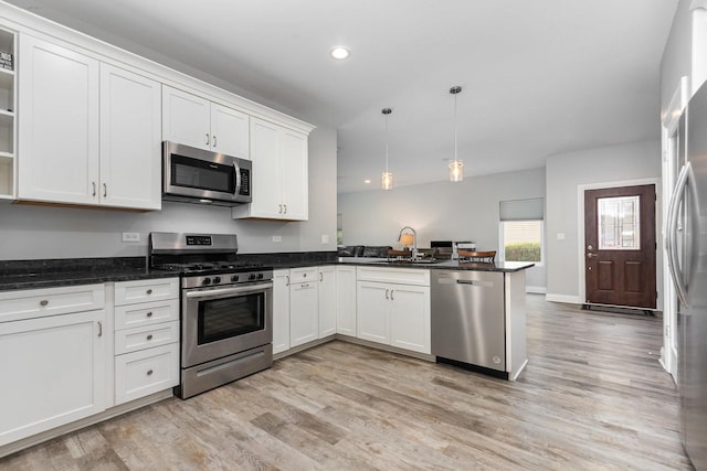 15710 S Cove Cir, Plainfield, IL 60544 - kitchen with appliances with stainless steel finishes, a peninsula, light wood-style flooring, white cabinets, and recessed lighting