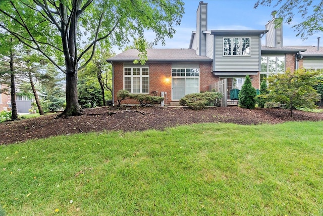 11257 Melrose Ct, Orland Park, IL 60467 - tri-level home with brick siding, a front yard, and a chimney
