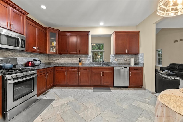 11257 Melrose Ct, Orland Park, IL 60467 - kitchen featuring appliances with stainless steel finishes, tasteful backsplash, recessed lighting, glass insert cabinets, and dark stone countertops