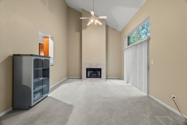 11257 Melrose Ct, Orland Park, IL 60467 - unfurnished living room featuring high vaulted ceiling, ceiling fan, light colored carpet, and a tiled fireplace