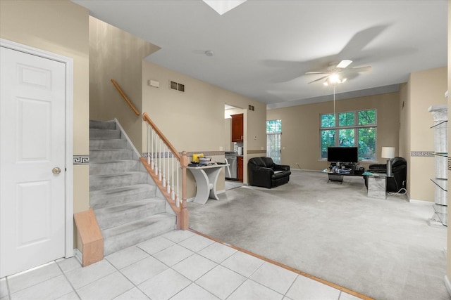11257 Melrose Ct, Orland Park, IL 60467 - living area with a ceiling fan, stairs, light colored carpet, and light tile patterned floors