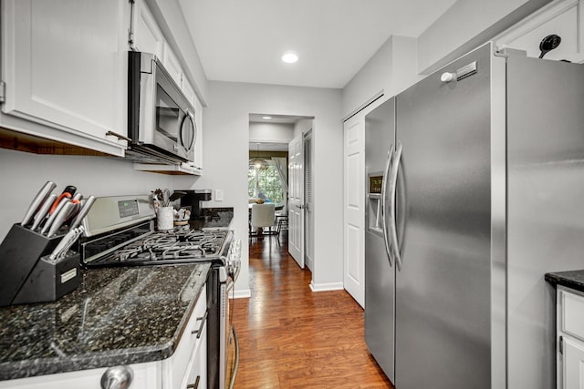 826 N Auburn Woods Dr, Palatine, IL 60067 - kitchen featuring stainless steel appliances, wood finished floors, white cabinets, dark stone countertops, and recessed lighting