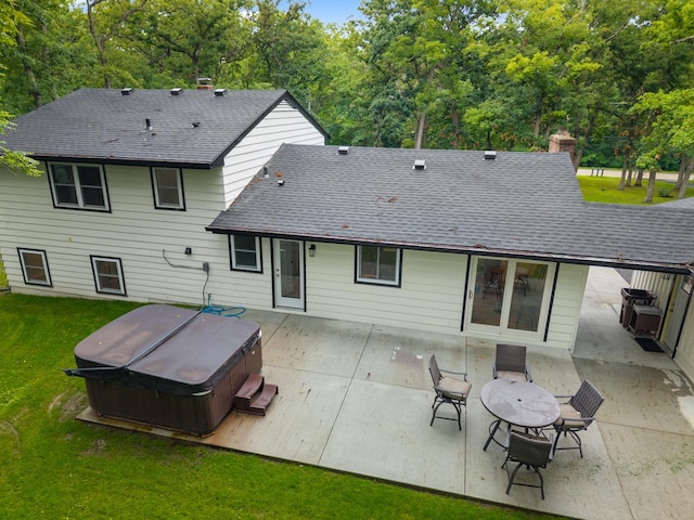 6427 Harlem Rd, Loves Park, IL 61111 - rear view of house with a hot tub, a patio, roof with shingles, and a yard