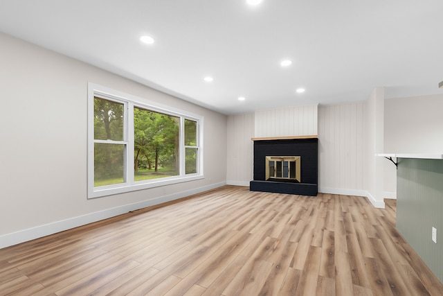 6427 Harlem Rd, Loves Park, IL 61111 - unfurnished living room featuring light wood-type flooring, recessed lighting, and a brick fireplace