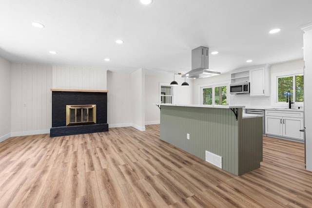 6427 Harlem Rd, Loves Park, IL 61111 - kitchen with range hood, stainless steel microwave, light wood-style flooring, and recessed lighting