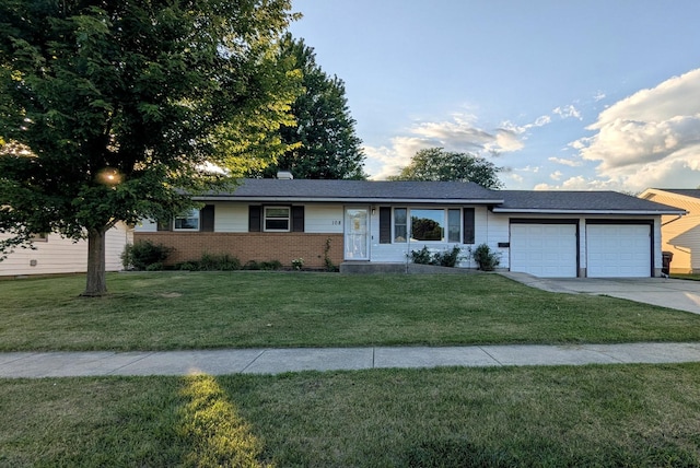 108 Janet Ave, Rochelle, IL 61068 - ranch-style home with an attached garage, a front lawn, concrete driveway, and brick siding