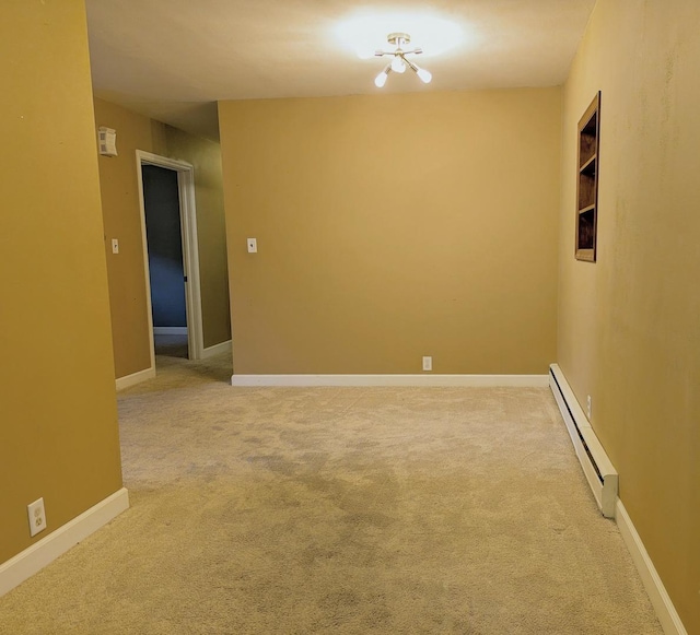 108 Janet Ave, Rochelle, IL 61068 - empty room with a baseboard heating unit and light colored carpet