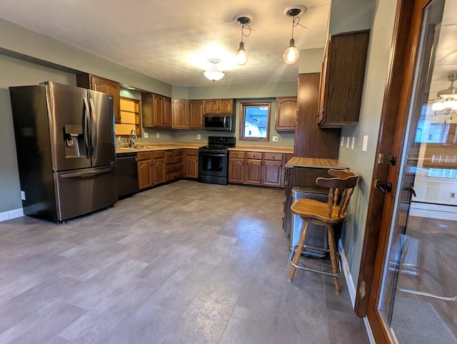 108 Janet Ave, Rochelle, IL 61068 - kitchen featuring black appliances, light countertops, and brown cabinets