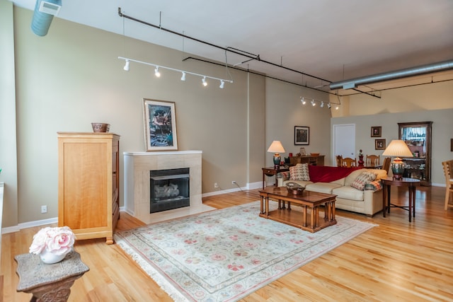 1020 S Wabash Ave Unit 7C, Chicago, IL 60605 - living room with rail lighting, a tiled fireplace, and wood finished floors