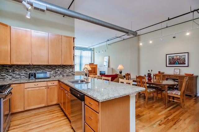 1020 S Wabash Ave Unit 7C, Chicago, IL 60605 - kitchen featuring appliances with stainless steel finishes, a peninsula, light wood-type flooring, decorative backsplash, and light stone countertops