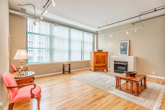 1020 S Wabash Ave Unit 7C, Chicago, IL 60605 - living room featuring rail lighting, wood finished floors, and a fireplace with flush hearth