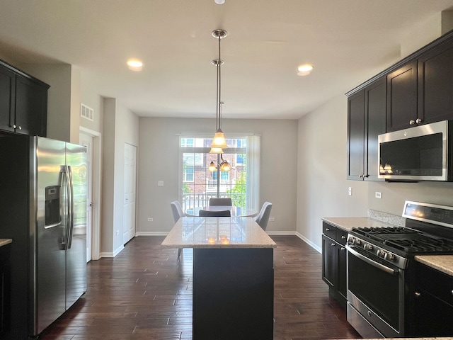 4182 Royal Mews Cir, Naperville, IL 60564 - kitchen featuring appliances with stainless steel finishes, dark wood-type flooring, light stone counters, a center island, and dark cabinets