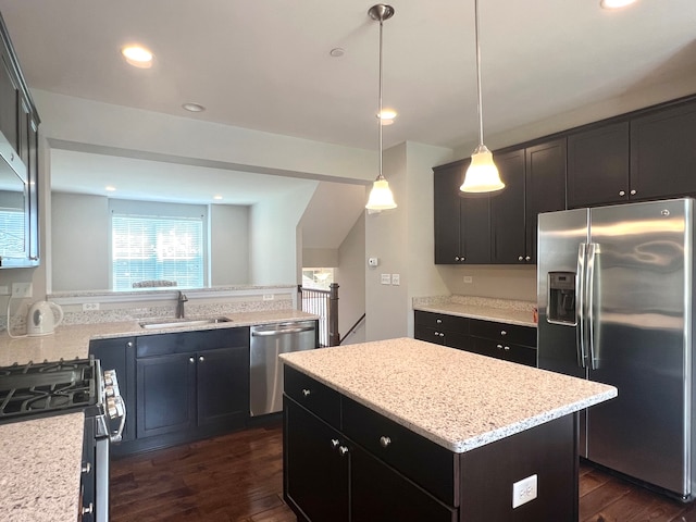 4182 Royal Mews Cir, Naperville, IL 60564 - kitchen with appliances with stainless steel finishes, dark wood-type flooring, a kitchen island, light stone counters, and decorative light fixtures
