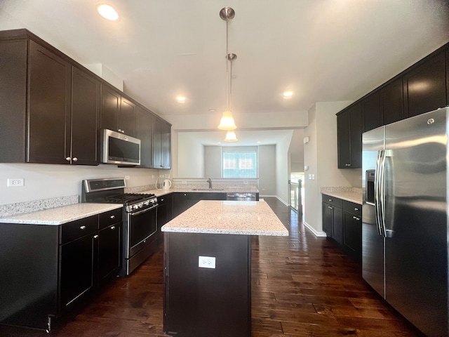 4182 Royal Mews Cir, Naperville, IL 60564 - kitchen featuring appliances with stainless steel finishes, a peninsula, dark wood finished floors, a center island, and hanging light fixtures