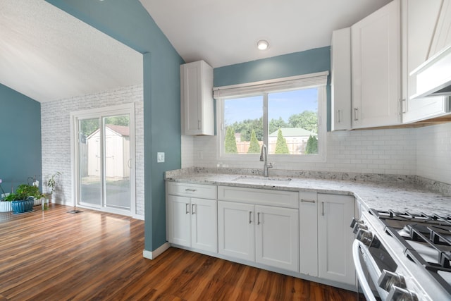 2S464 Cottonwood Ct, Warrenville, IL 60555 - kitchen with lofted ceiling, stainless steel range with gas cooktop, tasteful backsplash, white cabinets, and extractor fan