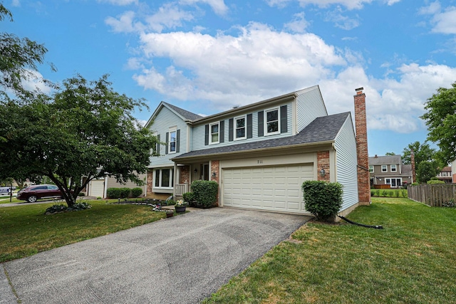 711 W Nichols Rd, Arlington Heights, IL 60004 - traditional-style home featuring asphalt driveway, brick siding, a chimney, and roof with shingles
