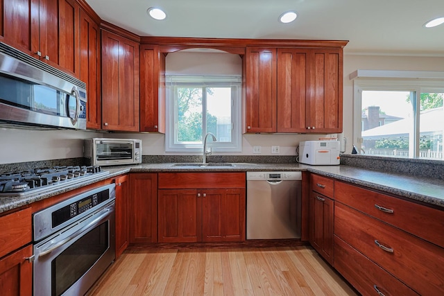 711 W Nichols Rd, Arlington Heights, IL 60004 - kitchen featuring appliances with stainless steel finishes, light wood finished floors, dark countertops, recessed lighting, and brown cabinets